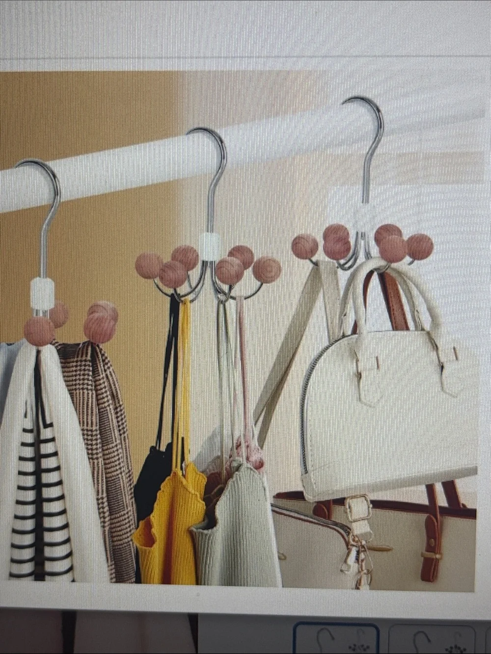 Chrome multi-hook hanger with round cedar wooden knob ends.